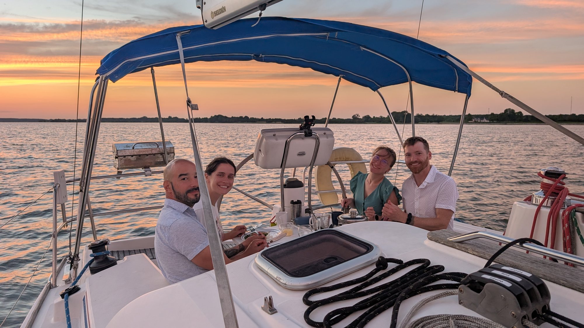 The crew at the cockpit table at sunset