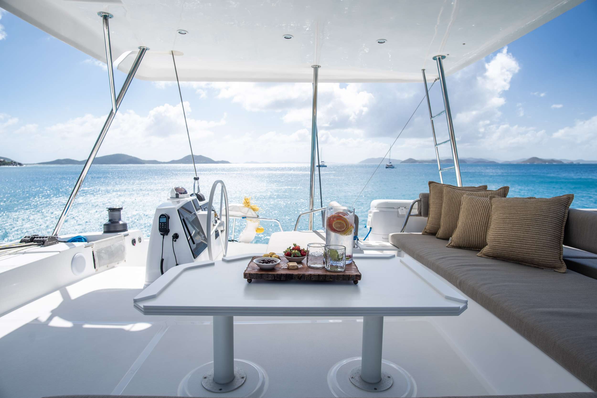 The helm and aft lounge of the catamaran underway